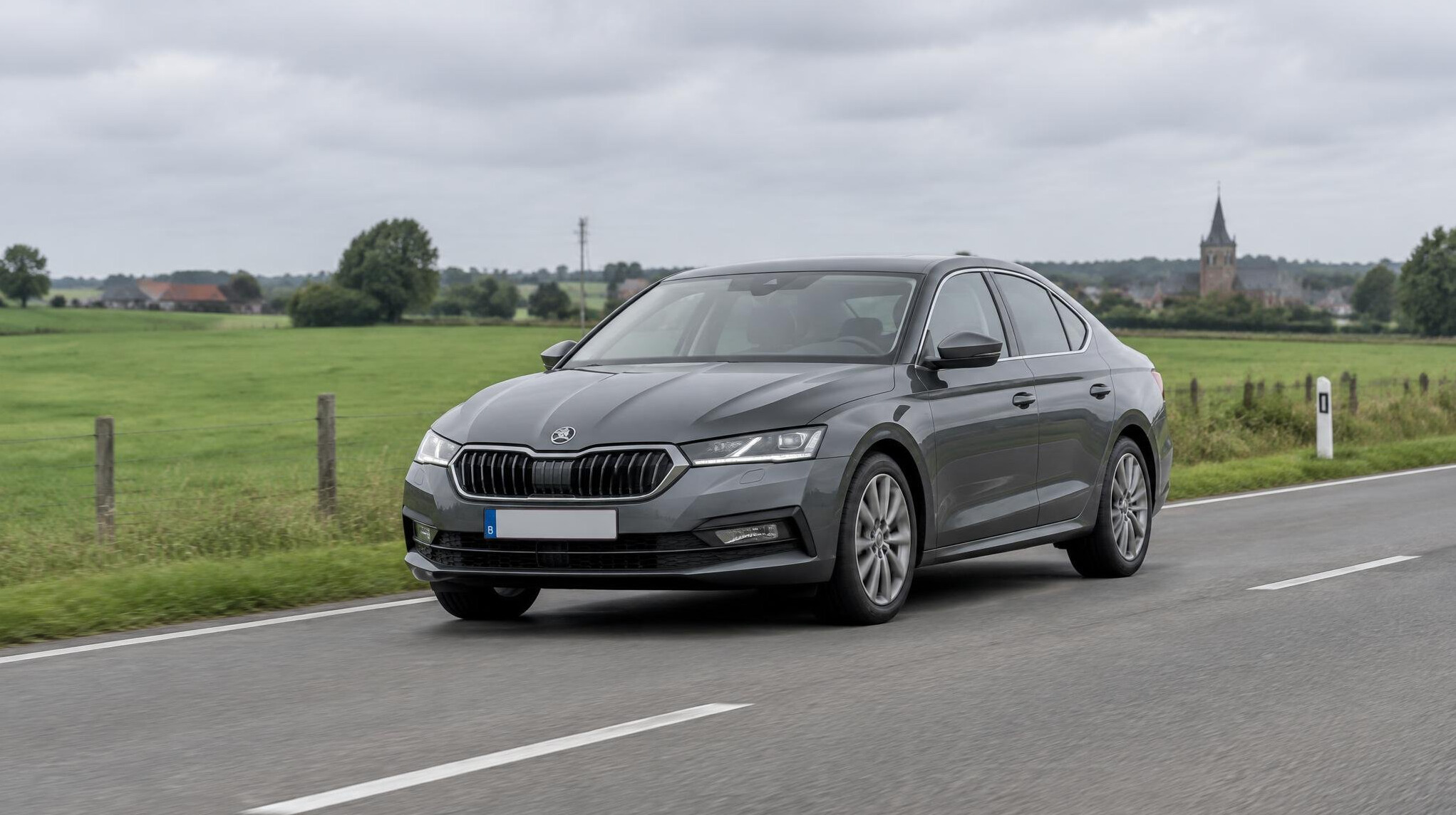 Grey car driving on a Belgian road in soft daylight